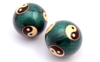 Green Chinese balls for relaxation on white background